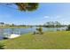 Spacious backyard with lush lawn, dock, and serene lake views, perfect for outdoor activities and relaxation at 1717 Danbury Dr, Sun City Center, FL 33573