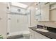 Bathroom with a glass enclosed shower, toilet, and a vanity with dark granite countertops at 1717 Danbury Dr, Sun City Center, FL 33573
