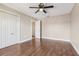 Bedroom with laminate floors, ceiling fan, and closet featuring double doors at 1717 Danbury Dr, Sun City Center, FL 33573