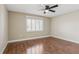 Bright bedroom with hardwood floors, ceiling fan, and plantation shutters at 1717 Danbury Dr, Sun City Center, FL 33573