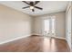 Spacious bedroom with hardwood floors, ceiling fan, and a sliding glass door to the exterior at 1717 Danbury Dr, Sun City Center, FL 33573