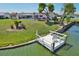 Waterfront home with a private dock and seating, perfect for enjoying the peaceful lake view at 1717 Danbury Dr, Sun City Center, FL 33573