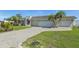 Wide driveway leading to a spacious two-car garage, surrounded by well-maintained landscaping at 1717 Danbury Dr, Sun City Center, FL 33573