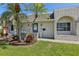 Inviting front entrance with decorative brickwork and lush tropical foliage flanking the doorway at 1717 Danbury Dr, Sun City Center, FL 33573