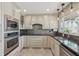 Bright kitchen with stainless steel appliances, granite countertops, and ample cabinetry at 1717 Danbury Dr, Sun City Center, FL 33573