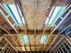 Close-up of a ceiling under construction, showcasing the framing and skylights designed to flood the space with natural light at 1821 Weekend Ln, Odessa, FL 33556