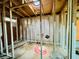 Framed interior view showing an open space room, with bare walls and wood-framed ceilings at 1821 Weekend Ln, Odessa, FL 33556