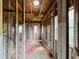 Exposed interior framing of a room with round skylight under construction, highlighting the structural elements and awaiting customization at 1821 Weekend Ln, Odessa, FL 33556