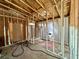 Framed interior view showing an open space room, with bare walls and wood-framed ceilings at 1821 Weekend Ln, Odessa, FL 33556