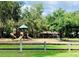 A colorful playground with slides and climbing structures is set in a lush, green park-like setting for Gathering fun at 1821 Weekend Ln, Odessa, FL 33556