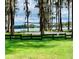 Lakeside volleyball court and picnic area surrounded by mature trees offer a perfect recreational spot at 1821 Weekend Ln, Odessa, FL 33556