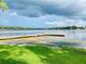 Scenic water view with a wooden pier extending into the water, great for fishing and boating at 1821 Weekend Ln, Odessa, FL 33556