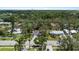 An aerial view showing a residential neighborhood with green trees and well-kept lawns on a sunny day at 1826 2Nd E Ave, Bradenton, FL 34208