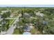 An aerial view of a residential area with green trees and houses on a sunny day, with a bridge in the distance at 1826 2Nd E Ave, Bradenton, FL 34208