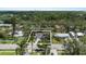 An aerial view of a quaint single-Gathering home featuring a well-manicured lawn and mature palm trees at 1826 2Nd E Ave, Bradenton, FL 34208