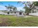 A large backyard with mature trees and a patio, perfect for relaxing outdoors at 1826 2Nd E Ave, Bradenton, FL 34208