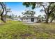 The home's backyard with ample green space and mature trees providing shade at 1826 2Nd E Ave, Bradenton, FL 34208