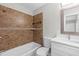 Bathroom featuring modern fixtures, stylish tiling, and a shower-tub combination at 1826 2Nd E Ave, Bradenton, FL 34208
