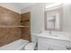Bathroom featuring modern fixtures, stylish tiling, and a shower-tub combination at 1826 2Nd E Ave, Bradenton, FL 34208