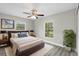 Relaxing bedroom with neutral tones, ceiling fan, and large windows offering natural light at 1826 2Nd E Ave, Bradenton, FL 34208