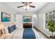 Bright bedroom with an ensuite, a ceiling fan, stylish art, and a view from the window at 1826 2Nd E Ave, Bradenton, FL 34208