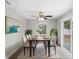 Elegant dining room featuring a ceiling fan, stylish decor, and sliding glass doors to the outdoors at 1826 2Nd E Ave, Bradenton, FL 34208