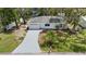 An exterior elevation showcasing a well-maintained home with a paved driveway and landscaped front yard at 1826 2Nd E Ave, Bradenton, FL 34208