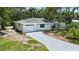 Charming single-story home with a well-manicured lawn and a long driveway at 1826 2Nd E Ave, Bradenton, FL 34208