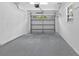 Clean and spacious garage with a gray epoxy floor, white walls and a window at 1826 2Nd E Ave, Bradenton, FL 34208