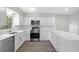 Modern kitchen with white cabinets, stainless steel appliances, and hardwood floors at 1826 2Nd E Ave, Bradenton, FL 34208