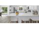Modern kitchen with stainless steel appliances, white cabinets, and breakfast bar at 1826 2Nd E Ave, Bradenton, FL 34208
