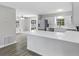 Open-concept kitchen featuring stainless appliances, white cabinets and island seating at 1826 2Nd E Ave, Bradenton, FL 34208