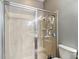 Walk-in shower featuring sleek tile work and a frameless glass door at 18339 Fish Loop, Land O Lakes, FL 34638
