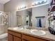 Bathroom featuring double sinks, vanity, and large mirror at 18339 Fish Loop, Land O Lakes, FL 34638