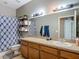 Bathroom featuring a shower with blue patterned curtain, vanity, and gray walls at 18339 Fish Loop, Land O Lakes, FL 34638