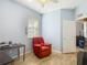 Bright bedroom offers a modern aesthetic with a red accent chair at 18339 Fish Loop, Land O Lakes, FL 34638