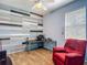 Bright bedroom offers a modern aesthetic with painted wood paneling and a red accent chair at 18339 Fish Loop, Land O Lakes, FL 34638