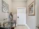 Bright entryway with a glass console table, decorative mirrors, and neutral-toned walls at 18339 Fish Loop, Land O Lakes, FL 34638
