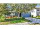 Charming single-Gathering home with a blue exterior, a well-manicured lawn, and an attached two-car garage at 18339 Fish Loop, Land O Lakes, FL 34638