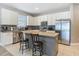 Kitchen with a kitchen island featuring granite countertops, stainless steel appliances, and a subway tile backsplash at 18339 Fish Loop, Land O Lakes, FL 34638
