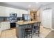 Kitchen with a kitchen island featuring granite countertops, stainless steel appliances, and a subway tile backsplash at 18339 Fish Loop, Land O Lakes, FL 34638