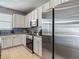 Modern kitchen featuring white cabinets, stainless steel appliances, granite countertops, and tile backsplash at 18339 Fish Loop, Land O Lakes, FL 34638
