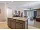 Kitchen with a kitchen island featuring granite countertops with an open view into the living room at 18339 Fish Loop, Land O Lakes, FL 34638