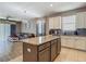 Open kitchen layout showcasing a center island with granite countertops, view into living room with natural light at 18339 Fish Loop, Land O Lakes, FL 34638