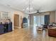 Spacious living room featuring a leather sectional couch, ceiling fan, and view into the kitchen at 18339 Fish Loop, Land O Lakes, FL 34638