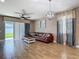 Spacious living room featuring a leather sectional couch, ceiling fan and natural lighting at 18339 Fish Loop, Land O Lakes, FL 34638