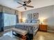 Bright main bedroom with a ceiling fan, window, and artwork at 18339 Fish Loop, Land O Lakes, FL 34638