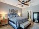 This main bedroom features a ceiling fan, neutral paint, and ensuite bathroom access at 18339 Fish Loop, Land O Lakes, FL 34638