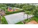 This aerial view highlights the community's beach volleyball court surrounded by picnic tables and a playground at 18339 Fish Loop, Land O Lakes, FL 34638