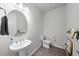 Tastefully designed powder room featuring a pedestal sink, a modern mirror, and minimalist decor at 19259 Mossy Pine Dr, Tampa, FL 33647